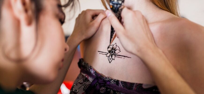 close-up-woman-drawing-mehndi-tattoo-female-chest_23-2148083174-9571211