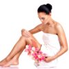 beautiful-young-woman-with-flowers-using-scrub_186202-8347-1216475